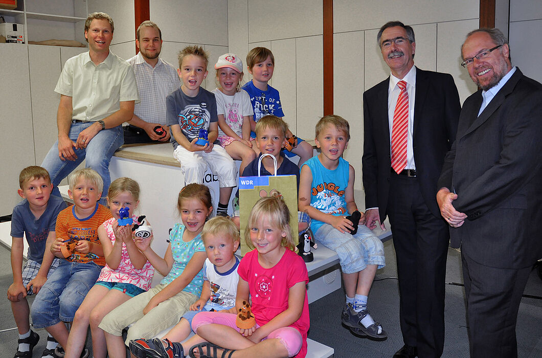Foto: Die Kinder des katholischen Kindergartens St. Johannes der Täufer auf dem useTable mit Holger Fischer und Helge Jung, Mitarbeiter des c-lab (hinten links), Hans Laven, Vorstandsvorsitzender der Sparkasse Paderborn (2. von rechts), und Prof. Reinhar