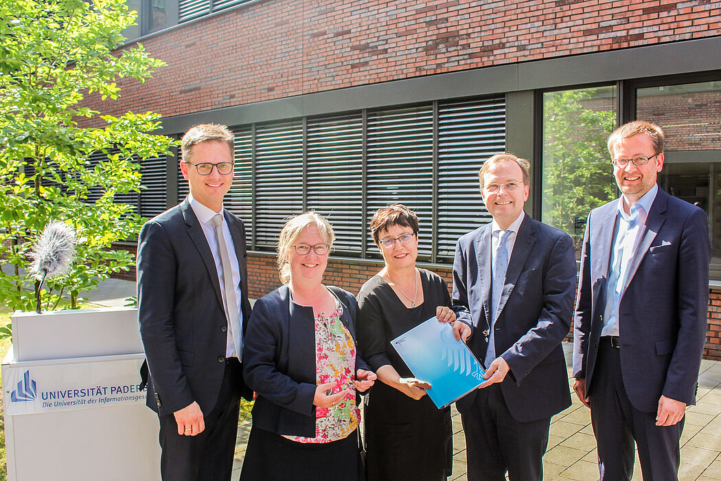 Foto (Universität Paderborn, Johannes Pauly): Übergabe des Zuwendungsbescheides: (v. l.) Dr. Carsten Linnemann MdB, Simone Probst, Vizepräsidentin für Wirtschafts- und Personalverwaltung, Prof. Dr. Birgit Riegraf, Vizepräsidentin für Lehre, Studium 