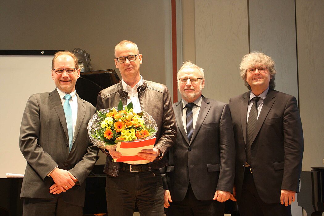 Foto (© HfM Detmold/Plettenberg): Dr. Ulrich Schwerdt (2. v. l.) bekommt den Titel Honorarprofessor verliehen.