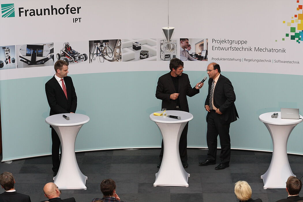 Foto: Ansgar Trächtler und Christian Brecher im Gespräch mit Michael Thamm.