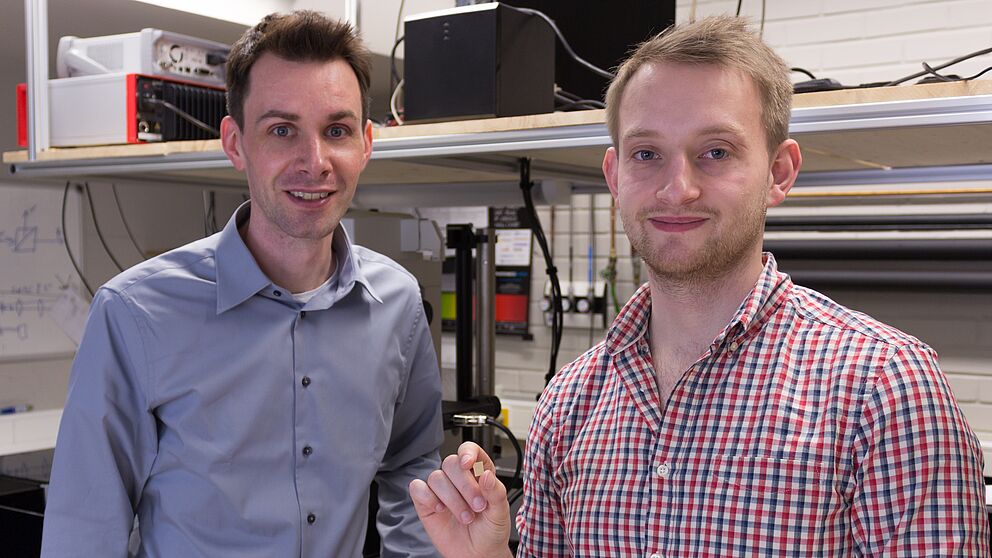 Bild (Department Physik): Prof. Dr. Thomas Zentgraf (links) und Masterstudent Bernhard Reineke (rechts) präsentieren im Optiklabor ihr entwickeltes nichtlineares optisches Material.