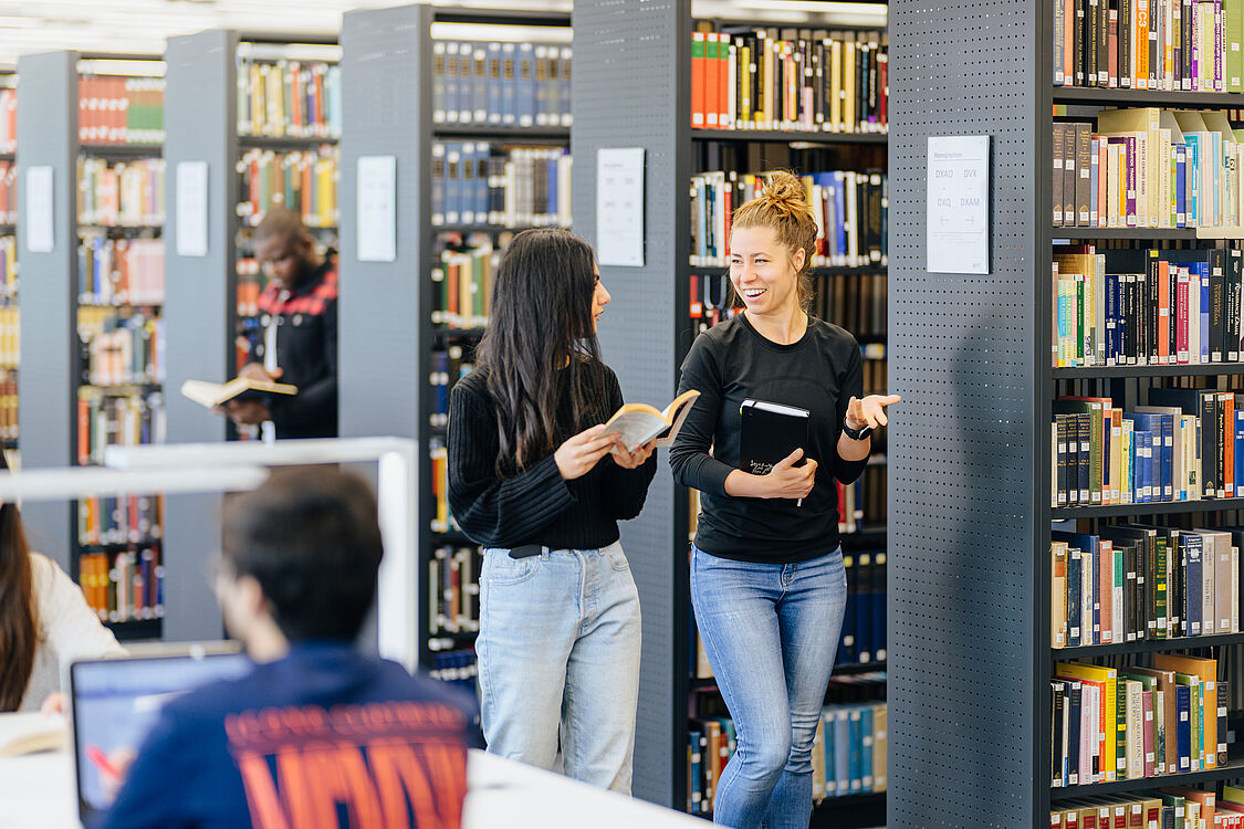 People in the library of Paderborn University.